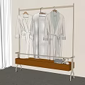 Soft Lightweight Robes Hanging on Metal Clothing Rack with Wooden Shelf and Plush Toy