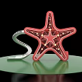 Decorative Red Starfish With Grid Light Bulbs And Silver S Shaped Object On Green Platform