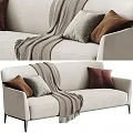 Modern Beige Two Seater Sofa With Brown Gray Pillows And Knitted Throw Blanket