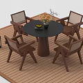 Round Outdoor Table with Four Wooden Mesh Chairs Flower Vase and Plant on Wooden Deck