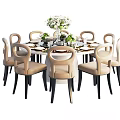 Modern Round Dining Table And Chairs Set With Beige Seats Black Legs White Flower Vase
