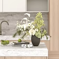 Gray Vase With White Green Flowers On Kitchen Countertop With Books Limes And Decor