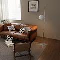 Modern Brown Leather Two Seater Sofa With Black White Throw Pillows Floor Lamp And Potted Plant