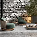 Outdoor Chairs With Green Cushions Wooden Armrests Round Design Stone Wall Background And Green Plants