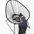 Modern Rattan Leisure Chair in Indoor Setting with Striped Backdrop