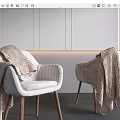 White Upholstered Leisure Chairs With Wooden Legs And Knitted Blankets In Minimalist Grey Room