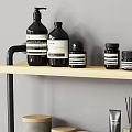 Stylish Modern Bathroom Accessories On Wooden Shelf With Bottles Jars Candles Toilet Paper And Boxes