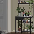 Black Multi Tier Plant Shelf With Potted Greenery And Decorative Plants