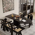 Black Oval Dining Table Set With Woven Chairs Flower Vase Food Items And Wall Art