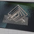 Modern Metallic Landscape Sculpture Featuring Interlocking Geometric Shapes Reflective Surface Green Trees And Blue Sky