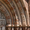 Romanesque Entrance Gate With Red Brick Structure Carved Archway Stone Columns And Wooden Doors