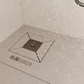Shower Drain 10x10 Size With Water Droplets On Bathroom Floor