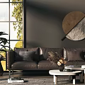 Modern Three-Seater Sofa with Large Window Natural Light Round Art Coffee Table and Green Plants