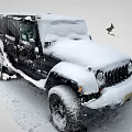 Black Jeep SUV Covered In Snow Standing In Winter Outdoor Snowy Scene