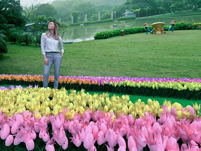 Woman Standing In Vibrant Tulip Field Enjoying Green Garden Lakeside View 3d model