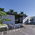 Water Fountain with Pool Reflection Surrounded by Trees Green Hedge Gray Wall Under Blue Sky