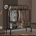 Various Colorful Clothes Hanging On Metal Clothes Rack With Bags And Suitcases In Bedroom Corner