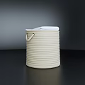White Towel Peeking Out of a Round White Woven Storage Basket