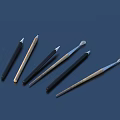 Various Craft Pens with Black Brown Colors and Different Tip Shapes on Dark Blue Background