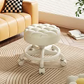 White Round Tufted Stool With Wheels On Striped Rug In Living Room