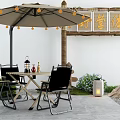 Outdoor Table With Umbrella String Lights And Chairs In Patio Setting With Lantern 3d model