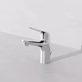 Modern Stainless Steel Faucet With Single Handle On White Bathroom Countertop