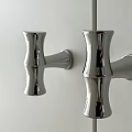 Chrome Cabinet Handles With Modern Sleek Curved Design On White Panel