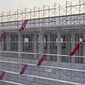 Tall Building Under Construction With Scaffolding Structure And Red Ladders 3d model