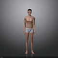 Shirtless Fit Man Standing In Light Colored Underwear Against Gray Background