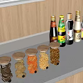 Spice Bottles And Transparent Jars With Snacks On Kitchen Countertop By Wooden Cabinets