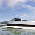 Modern Streamlined Museum Building With Glass Curtain Wall And Water Pool Reflection