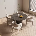 Modern Round Dining Table Set with Four Chairs Vase Lemons on Sunlit Wooden Floor