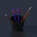Purple Pens and Red Pencils in Black Cup with White Tips on Dark Desk