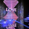 Illuminated Spiral Structure With LOVE Sign And Lotus Decorations Art Installation