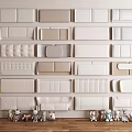 Different Styles Of Upholstered Panels Displayed On Wall With Decorative Toys And Plant