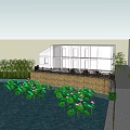 Water Fountain Feature With Lotus Flowers And Building Near Stone Railing