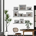 Stylish Photo Wall Decor with Framed Pictures on White Wall and Potted Plants