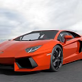 Orange Lamborghini Supercar With Sleek Design Black Wheels On Open Ground Against Cloudy Sky Background