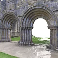 Serene Garden Landscape Featuring Ancient Stone Arches Stone Path And Green Grass