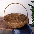 Woven Rattan Basket On Wooden Table With Green Plant And Blue Cloth