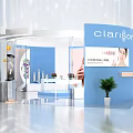 Modern Circular Exhibition Booth With Blue White Design Product Display Digital Screens And Green Plants