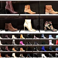 Display Shelves Showcasing Various Stylish Boots And Colorful Shoes With Unique Designs