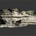 Layered Rock Formation Featuring Natural Arch And Green Vegetation On Textured Surface