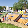Colorful Children's Play Area With Slides Climbing Frames Sand And Trees For Kids Playing