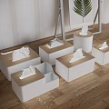 Display Setup With White Cube Stands Folded Items Leaf Artwork Striped Wall And Wooden Floor