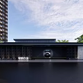 Modern Black Entrance Gate With Circular Design Tall Building And Green Trees