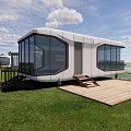 Modern Boutique Guesthouse Building With Large Glass Windows Wooden Deck And Waterfront View