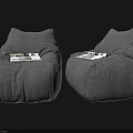Two Gray Linen Bean Bag Chairs with Magazines for Comfortable Seating