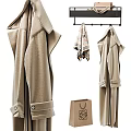 Stylish Beige Coats Hanging On Rack With Scarf And Paper Bag