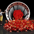 Giant Cone Structure Featuring Latinum Days Text With Scattered Red Orange Flowers And Small Figure